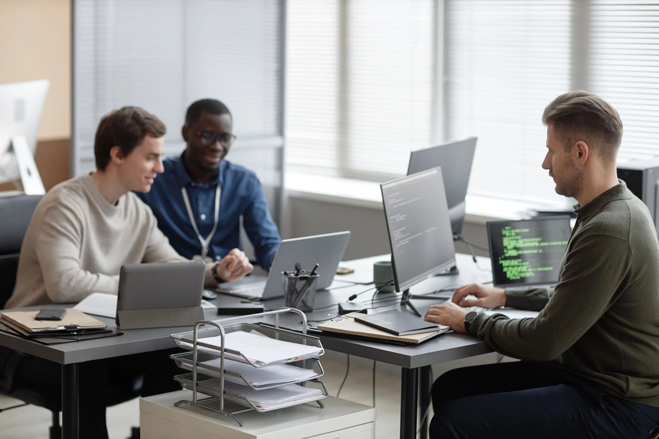 Collaborative editorial team working in a modern newsroom