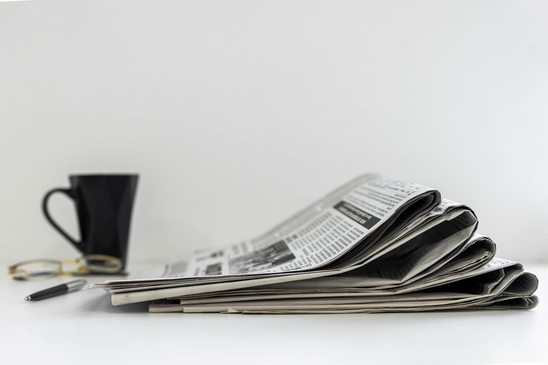 Newspapers and coffee on a desk